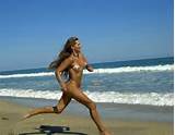 naked girl running on beach, nude in public, long hair, tan lines ...
