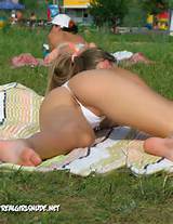 PL7a2vTh Pussy slip in public while tanning. Lips exposed in thong